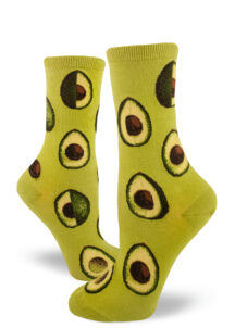 Avocados in various stages of being sliced make up the pattern on these green crew socks for women.
