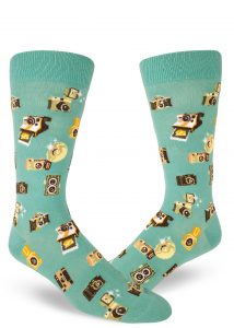 A pattern made from vintage cameras on turquoise men's crew socks.