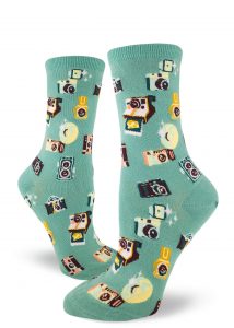 A pattern made from vintage cameras on turquoise women's crew socks.