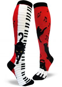 red and black womens knee socks featuring a black cat on piano keys