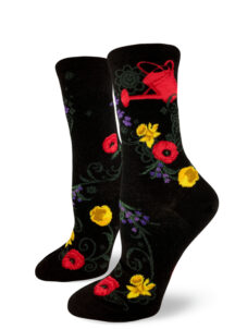 A red watering can and various garden flowers make up this black women's crew sock.