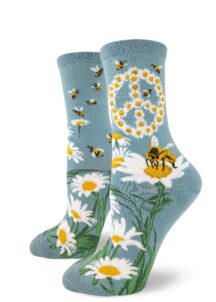A peace sign made out of daisies with bees buzzing around on these blue crew socks for women.