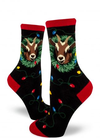 A goat eats a string of Christmas lights with a wreath around its neck on Christmas goat socks for women.