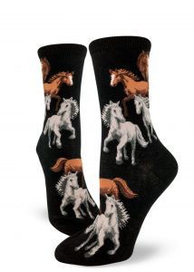 Brown and white horses prance together on these black crew socks for women.