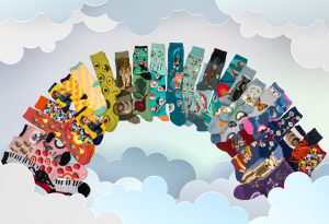 A rainbow of colorful socks in novelty designs including socks with animals on them, floral socks, Rosie the Riveter socks and food socks.