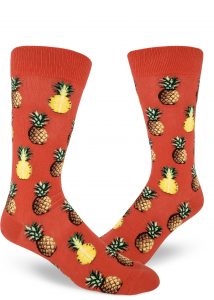 Pineapple fruit sit comfortably on these coral men's crew socks.