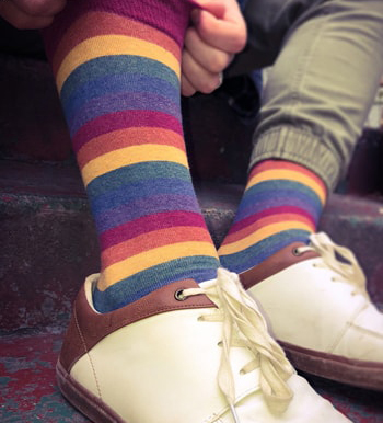 rainbow-socks-modsocks-novelty-sock-brand-wholesale Rainbow striped socks by ModSocks worn at the gay pride parade.