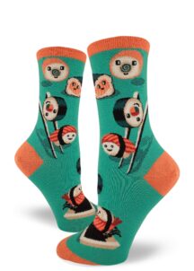 Sushi rolls and nigiri with happy faces play around with chopsticks and soy sauce on these aqua women's crew socks.