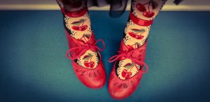 Cherry socks in knee high by ModSocks are paired with red leather shoes for a pin-up style.
