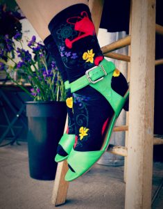 Gardening socks with a red watering can pouring out a variety of flowers by ModSocks.