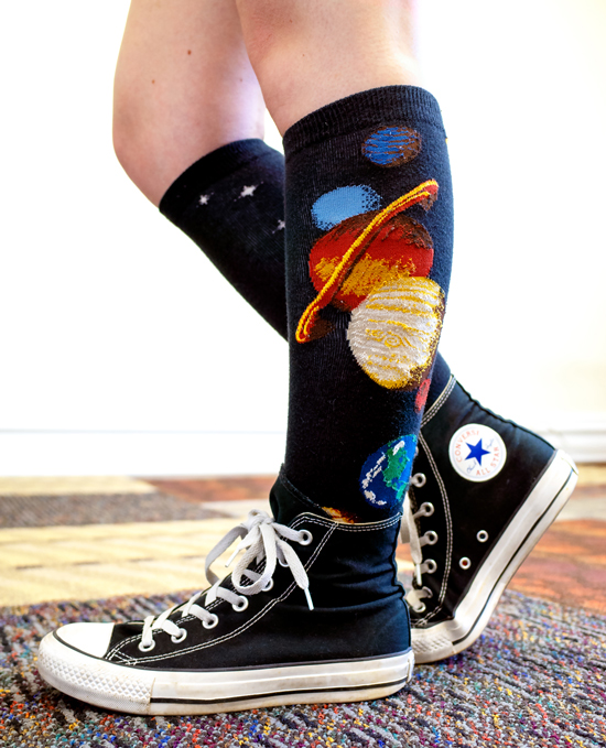 Solar system socks by ModSocks in black knee high with planets in converse style.