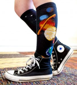 Solar system socks by ModSocks in black knee high with planets in converse style.