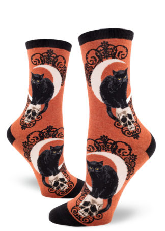 Heather sienna women's crew socks with a design featuring a black cat hunched on a skull in front of a crescent moon.