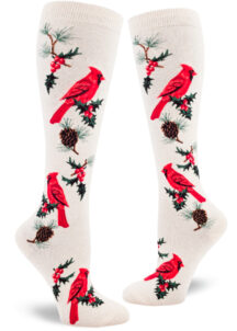 Cardinal knee socks with a cardinal bird and holly berry design on a cream background.