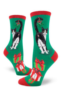 A sprig of mistletoe hangs from a tuxedo cat's tail as he shows off his butthole on these funny novelty Christmas socks.