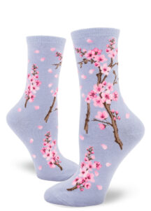 Cherry blossom crew socks with a pink floral design on a light violet background.