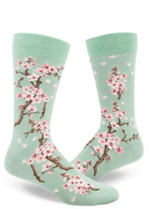 Men's cherry blossom socks with a pink floral design on a light green background.