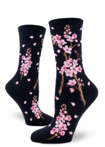 Cherry blossom crew socks with a pink floral design on a deep navy background.