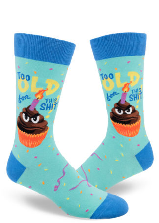 Funny men's crew socks that say "Too old for this shit!" on the side have an image of a grumpy cupcake with a flaming birthday candle.