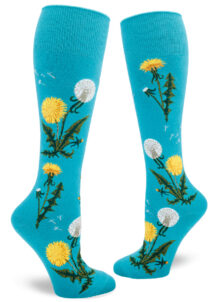 Dandelion knee socks with bright yellow flowers, white seed heads and green leaves on a blue background.