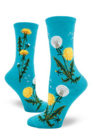 Dandelion crew socks with bright yellow flowers, white seed heads and green leaves on a blue background.
