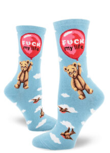 A teddy bear is carried away by a big red balloon that says "Fuck my life" while birds swoop through the cloud-filled sky blue background of these women's crew socks.