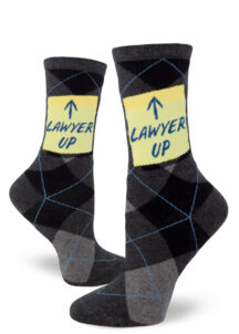Argyle socks say "Lawyer Up" with an arrow on a sticky note.