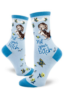 Funny dog socks feature a puppy playing with butterflies and say "Not your bitch."
