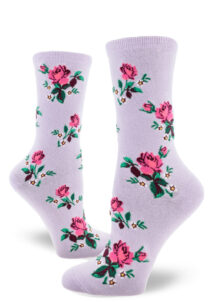 Floral women's crew socks with a pink rose motif accented by small white flowers over a wisteria purple background.