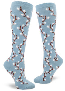 Knee-high socks with a repeating pattern of fuzzy pussy willow branches on a slate blue background.