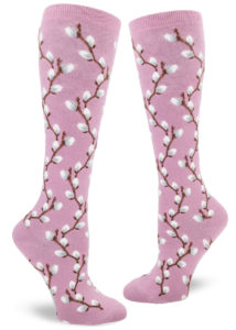 Knee-high socks with a repeating pattern of fuzzy pussy willow branches on a mauve background.