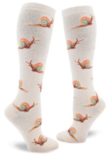 Heather cream knee socks with an allover repeating pattern of snails with rainbow shells, trailing rainbow slime.