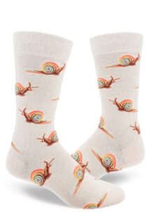 Heather cream men's crew socks with an allover repeating pattern of snails with rainbow shells, trailing rainbow slime.