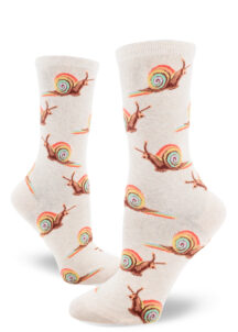 Heather cream women's crew socks with an allover repeating pattern of snails with rainbow shells, trailing rainbow slime.