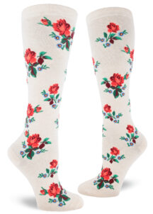 Floral knee socks with a red rose motif accented by small blue flowers over a heather cream background.