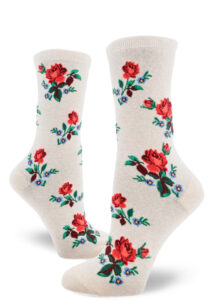 Floral women's crew socks with a red rose motif accented by small blue flowers over a heather cream background.
