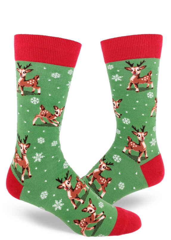 Red-accented green men's crew socks featuring a design of kitschy retro baby reindeer playing in a flurry of snowflakes.