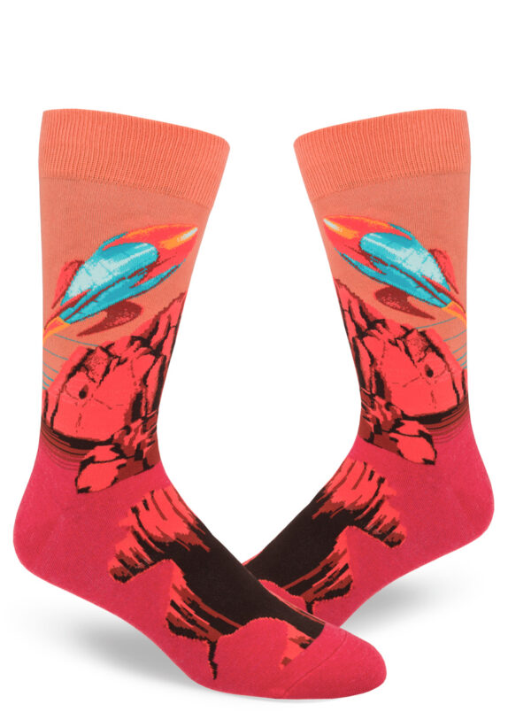 Red and orange men's socks show a blue retro rocket leaving the planet Mars.