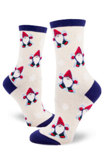 Gnomes dressed in red caps, mittens and boots make snow angels on these festive women's crew socks with a heather cream background.