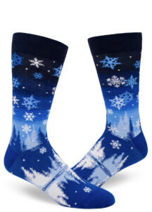 Snowflake men's socks depict a winter scene over a blue gradient striped sky.