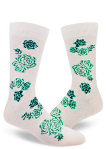 Men's crew socks with a design of green, purple and pink succulent plants on a heather cream background.